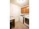 Well-equipped laundry room with washer, dryer, storage cabinets, and functional workspace at 2049 Maybelles Ln, Charleston, SC 29414