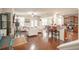 Spacious open concept living room with hardwood floors, white sofas, and a kitchen view at 2049 Maybelles Ln, Charleston, SC 29414