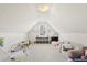Versatile attic space with cozy seating, play area, soft carpet, and plenty of natural light at 2050 S Smokerise Way, Mount Pleasant, SC 29466