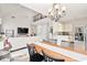 Open dining area with hardwood floors, a chandelier, and seamless access to the kitchen and living room at 2050 S Smokerise Way, Mount Pleasant, SC 29466