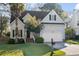 Charming two-story home with a well-maintained lawn, mature landscaping, and an attached two-car garage at 2050 S Smokerise Way, Mount Pleasant, SC 29466