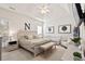 Spacious main bedroom featuring a tray ceiling, neutral decor, and an adjacent seating area with natural light at 2050 S Smokerise Way, Mount Pleasant, SC 29466