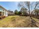 Expansive backyard with lush lawn, mature trees, and a charming wooden fence at 2052 Bancroft Ln, Mount Pleasant, SC 29466
