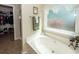A close-up view of a garden style tub with a view to the walk-in closet and glass enclosed shower at 2052 Bancroft Ln, Mount Pleasant, SC 29466