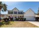 Charming two-story home featuring a front porch, American flag, and meticulous landscaping in a desirable location at 2052 Bancroft Ln, Mount Pleasant, SC 29466
