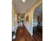 Inviting hallway featuring hardwood floors, wainscoting, neutral paint, and an arched entryway at 2052 Bancroft Ln, Mount Pleasant, SC 29466