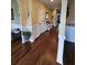 Inviting hallway featuring hardwood floors, wainscoting, neutral paint, and an open entryway at 2052 Bancroft Ln, Mount Pleasant, SC 29466