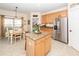 Kitchen featuring a central island with granite countertops, stainless steel refrigerator and an adjacent dining area at 2052 Bancroft Ln, Mount Pleasant, SC 29466