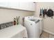 Practical laundry room equipped with modern washer and dryer units, complemented by storage cabinets at 2052 Bancroft Ln, Mount Pleasant, SC 29466