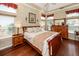 Comfortable bedroom with hardwood floors, tray ceiling, and ample natural light at 2052 Bancroft Ln, Mount Pleasant, SC 29466