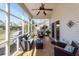 Relaxing screened porch features comfortable wicker furniture and an overhead ceiling fan at 2052 Bancroft Ln, Mount Pleasant, SC 29466