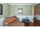 Inviting sitting room with hardwood floors, cozy armchair, and decorative accents at 2052 Bancroft Ln, Mount Pleasant, SC 29466