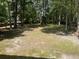 Spacious backyard featuring mature trees and a partially visible wooden fence at 208 Woodland Dr, Summerville, SC 29485