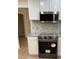 Modern kitchen featuring stainless steel appliances, white cabinets, and a stylish backsplash at 208 Woodland Dr, Summerville, SC 29485