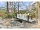 Charming backyard water feature with a bridge and fountain, surrounded by mature trees at 211 Logan Dr, Summerville, SC 29483