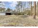 Large backyard with a deck, patio area, landscaping, and mature trees at 211 Logan Dr, Summerville, SC 29483