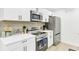 Modern kitchen featuring stainless steel appliances, white cabinets, and a clean design, perfect for culinary enthusiasts at 211 Logan Dr, Summerville, SC 29483