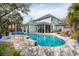 Inviting backyard features a refreshing pool, relaxing lounge chairs, and a screened-in porch at 2165 Annie Laura Ln, Mount Pleasant, SC 29466