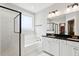 Bright bathroom featuring a modern shower, soaking tub, and vanity with black countertop and gold hardware at 2165 Annie Laura Ln, Mount Pleasant, SC 29466