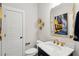 Stylish half-bathroom features a unique mirror, pedestal sink, and elegant decor for a chic look at 2165 Annie Laura Ln, Mount Pleasant, SC 29466