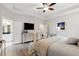 Bright main bedroom featuring a tray ceiling, hardwood floors, and an ensuite bathroom at 2165 Annie Laura Ln, Mount Pleasant, SC 29466