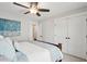 Comfortable bedroom with large bed featuring blue and white bedding, a ceiling fan, and double closets at 2165 Annie Laura Ln, Mount Pleasant, SC 29466