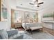 Inviting primary bedroom showcasing a four-poster bed, tray ceiling, ceiling fan, and hardwood floors at 2165 Annie Laura Ln, Mount Pleasant, SC 29466