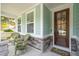 Inviting front porch with rocking chairs, beautiful stone accents, and a welcoming entrance at 2165 Annie Laura Ln, Mount Pleasant, SC 29466