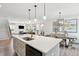 Bright kitchen features quartz counters, stainless steel appliances, and an open layout to living and dining areas at 2165 Annie Laura Ln, Mount Pleasant, SC 29466