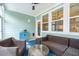 Relaxing enclosed patio area with ceiling fan, blue rug, and comfortable wicker furnishings at 2165 Annie Laura Ln, Mount Pleasant, SC 29466