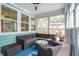 Cozy sunroom with wicker furniture, including a sofa and chairs, offering a tranquil view of the pool at 2165 Annie Laura Ln, Mount Pleasant, SC 29466