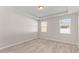 This bedroom features two windows, and wood-look floors, offering natural light and contemporary style at 223 Sugarberry Lane, Moncks Corner, SC 29461