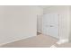 Well-lit bedroom featuring carpet floors, ample closet space, and fresh neutral walls, creating a relaxing atmosphere at 223 Sugarberry Lane, Moncks Corner, SC 29461