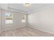 Bright bedroom featuring tray ceilings, hardwood floors, and large windows allowing natural light at 223 Sugarberry Lane, Moncks Corner, SC 29461