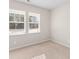 Cozy bedroom with plush carpet, neutral walls, and natural light streaming through the two bright windows at 223 Sugarberry Lane, Moncks Corner, SC 29461