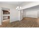 Open dining area offers hardwood floors, neutral colors, view to kitchen, and modern chandelier at 223 Sugarberry Lane, Moncks Corner, SC 29461