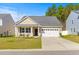 Charming single-story home with tan siding, black shutters, and an attached white single-car garage at 223 Sugarberry Lane, Moncks Corner, SC 29461
