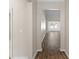 Inviting hallway featuring sleek, dark-toned hardwood flooring and views of the home's open-concept living spaces at 223 Sugarberry Lane, Moncks Corner, SC 29461