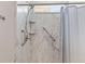Walk-in shower features elegant marble-look walls, a rain shower head, a handheld sprayer, and grab bars at 223 Sugarberry Lane, Moncks Corner, SC 29461