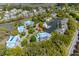 Scenic aerial view of waterfront condos with blue roofs and lush landscaping by the lake and marsh at 2472 Racquet Club Dr, Seabrook Island, SC 29455