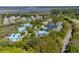 Breathtaking aerial view of waterfront condos nestled among trees with a view of the lake and bay beyond at 2472 Racquet Club Dr, Seabrook Island, SC 29455