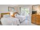 Inviting bedroom featuring twin beds, balcony access, and a warm ambiance for a relaxing retreat at 2472 Racquet Club Dr, Seabrook Island, SC 29455