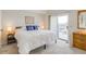 Inviting bedroom with a king-sized bed, neutral walls, and a door to the balcony at 2472 Racquet Club Dr, Seabrook Island, SC 29455