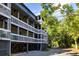 Condo building with multiple balconies, situated in a lush, green environment near a quiet street at 2472 Racquet Club Dr, Seabrook Island, SC 29455