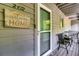 Charming front porch with 'Welcome to our Home' sign, glass screen door, and inviting seating area at 2472 Racquet Club Dr, Seabrook Island, SC 29455