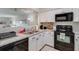 Open kitchen with white cabinetry and modern appliances, integrated into the living space at 2472 Racquet Club Dr, Seabrook Island, SC 29455