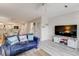Bright living room with a blue sofa, a television, and light gray floors at 2472 Racquet Club Dr, Seabrook Island, SC 29455