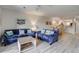 Bright living area with plush couches, stylish decor, and an open layout connecting to the dining room at 2472 Racquet Club Dr, Seabrook Island, SC 29455