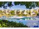 Community pool featuring outdoor seating, landscaping, and a beautiful view of the townhomes at 2472 Racquet Club Dr, Seabrook Island, SC 29455