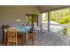 Outdoor porch featuring wooden furniture and a table with a patterned tablecloth at 2472 Racquet Club Dr, Seabrook Island, SC 29455